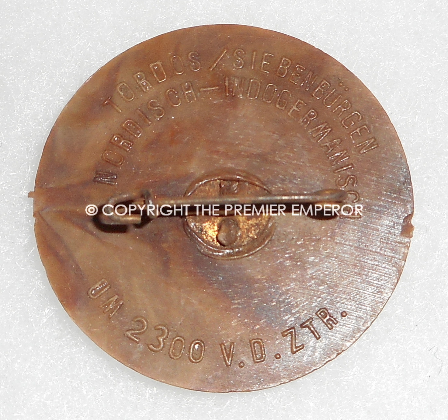 German Tinnie/Day badge. "Tordos/Siebenburgen,Nordisch-Indogermanisch" plastic WHW Runic insignia. Circa.1930's/1940's.
